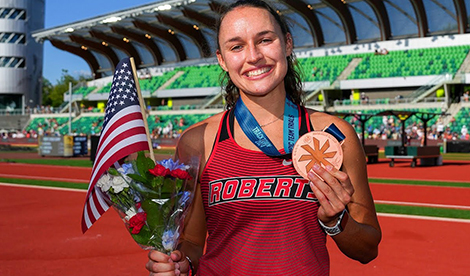 Brynn smiles with medal